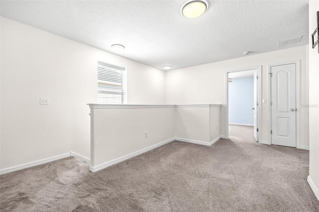 16713 Scenic Hill Way Wimauma, FL 33598 - Photo 21 of 52 an empty room with windows