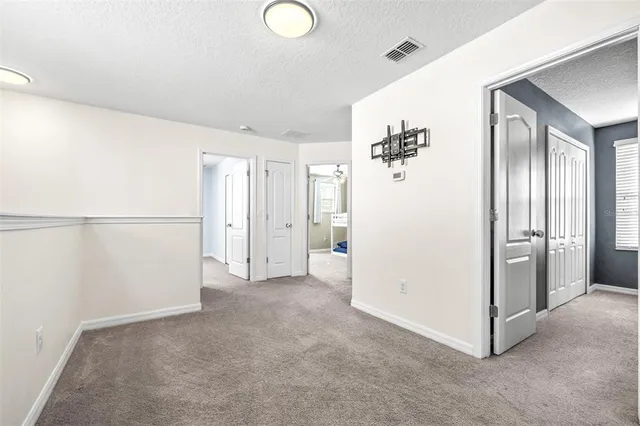 a view of a big room with closet and chandelier fan