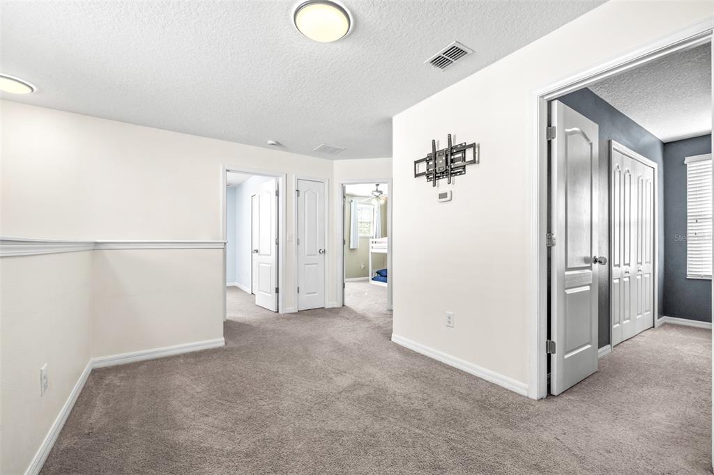 16713 Scenic Hill Way Wimauma, FL 33598 - Photo 22 of 52 a view of a big room with closet and chandelier fan