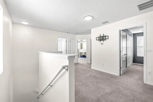 a view of a livingroom with wooden floor and staircase