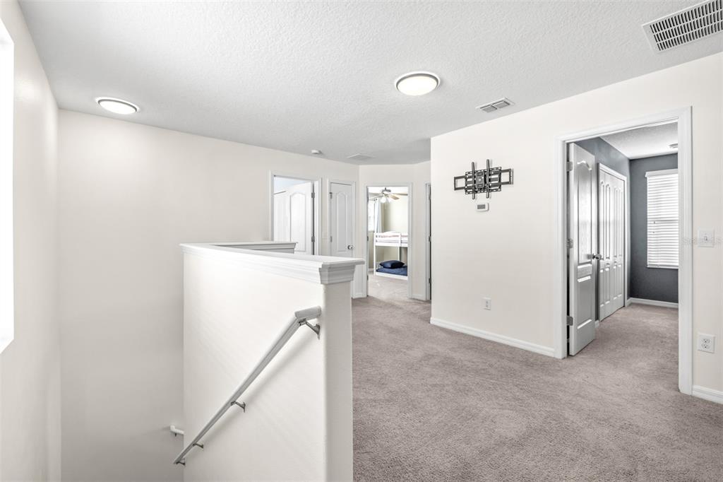 16713 Scenic Hill Way Wimauma, FL 33598 - Photo 23 of 52 a view of a livingroom with wooden floor and staircase