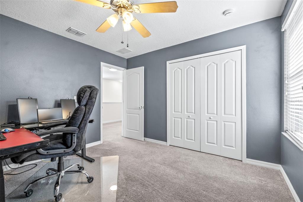 16713 Scenic Hill Way Wimauma, FL 33598 - Photo 30 of 52 a view of a workspace with furniture and a window