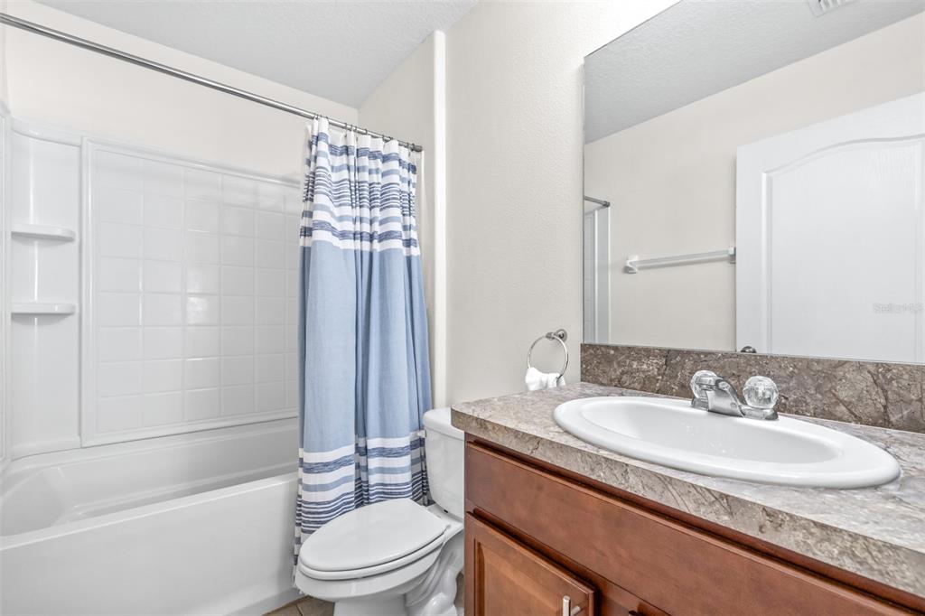 16713 Scenic Hill Way Wimauma, FL 33598 - Photo 31 of 52 a bathroom with a sink toilet and shower