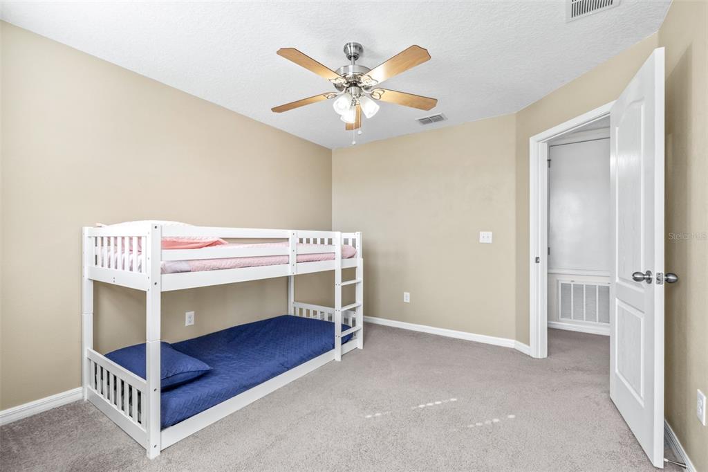 16713 Scenic Hill Way Wimauma, FL 33598 - Photo 33 of 52 a bedroom with bed and a table