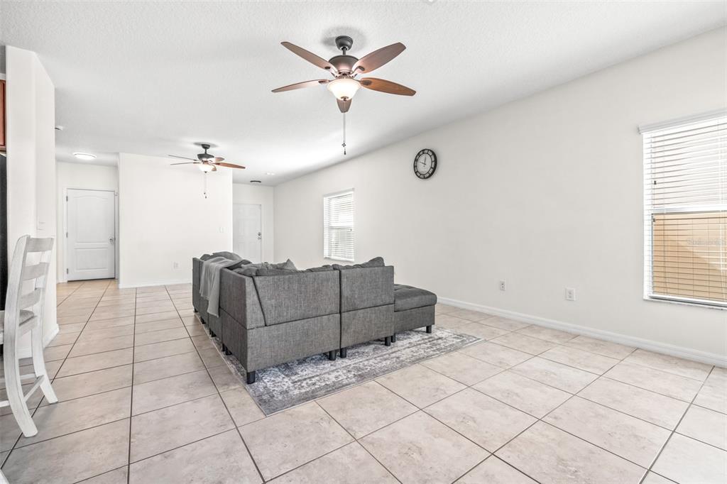 16713 Scenic Hill Way Wimauma, FL 33598 - Photo 6 of 52 a living room with furniture and a ceiling fan
