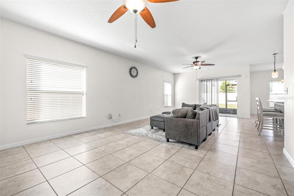 16713 Scenic Hill Way Wimauma, FL 33598 - Photo 7 of 52 a living room with furniture and a chandelier