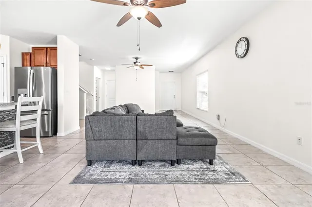 a living room with a couch and a chandelier