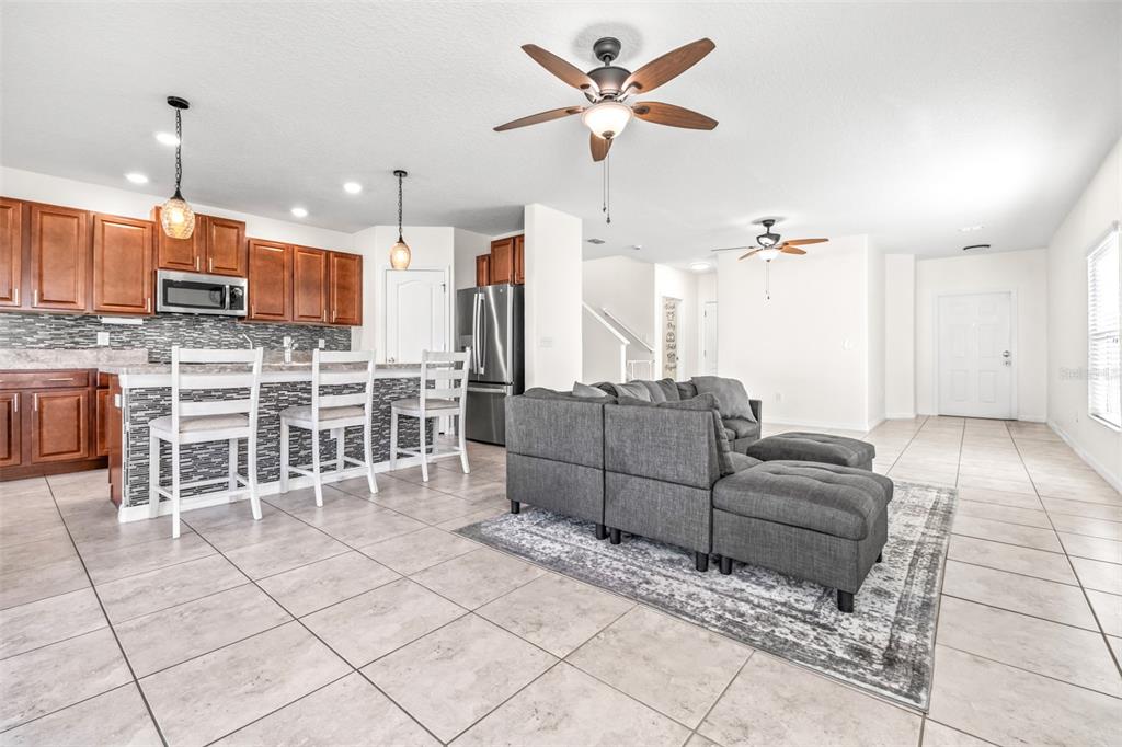 16713 Scenic Hill Way Wimauma, FL 33598 - Photo 9 of 52 a living room with furniture a ceiling fan and a rug
