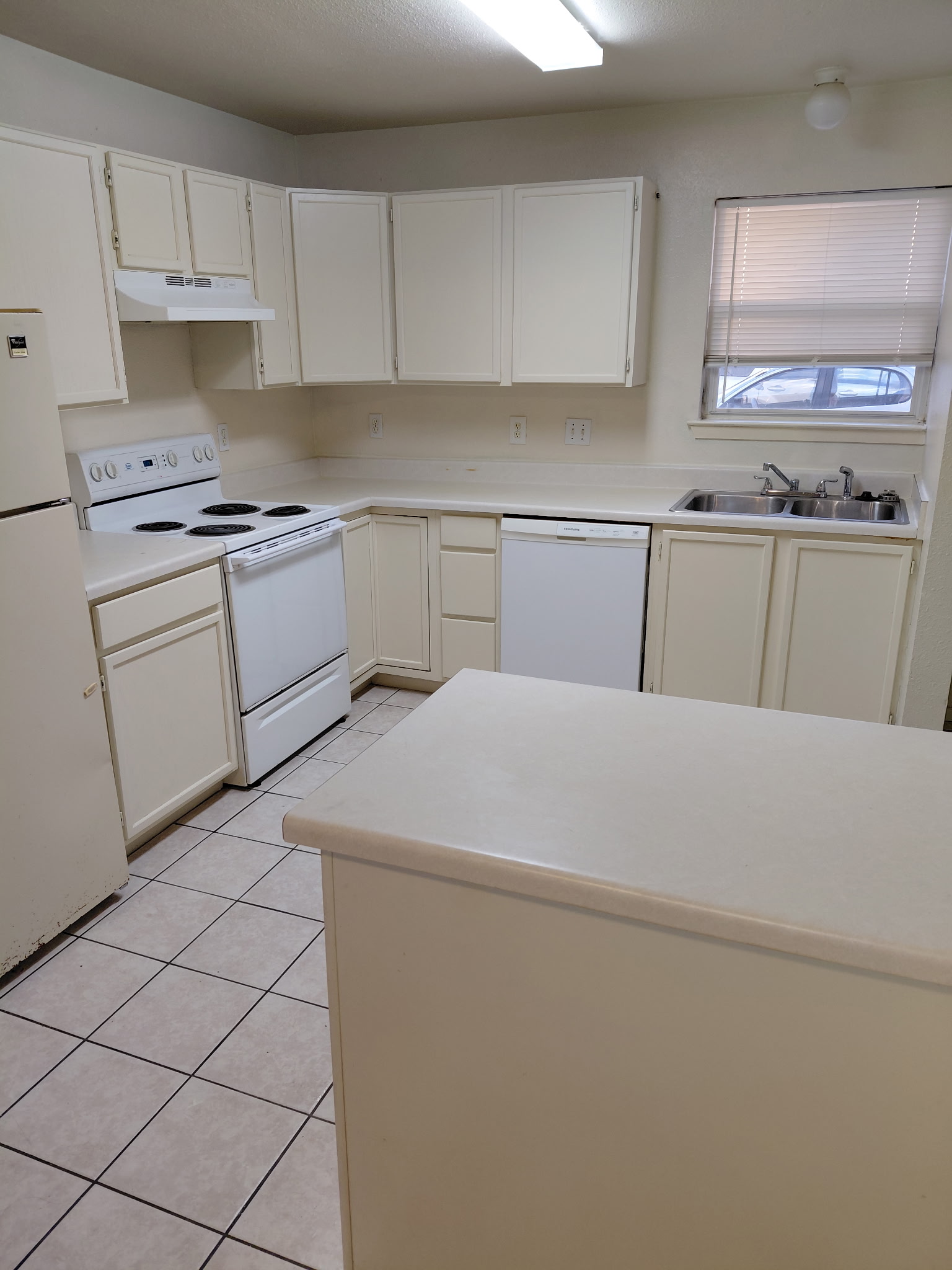 2218 Katy Lane Georgetown, TX 78626 - Photo 2 of 10 a kitchen with white cabinets and white appliances