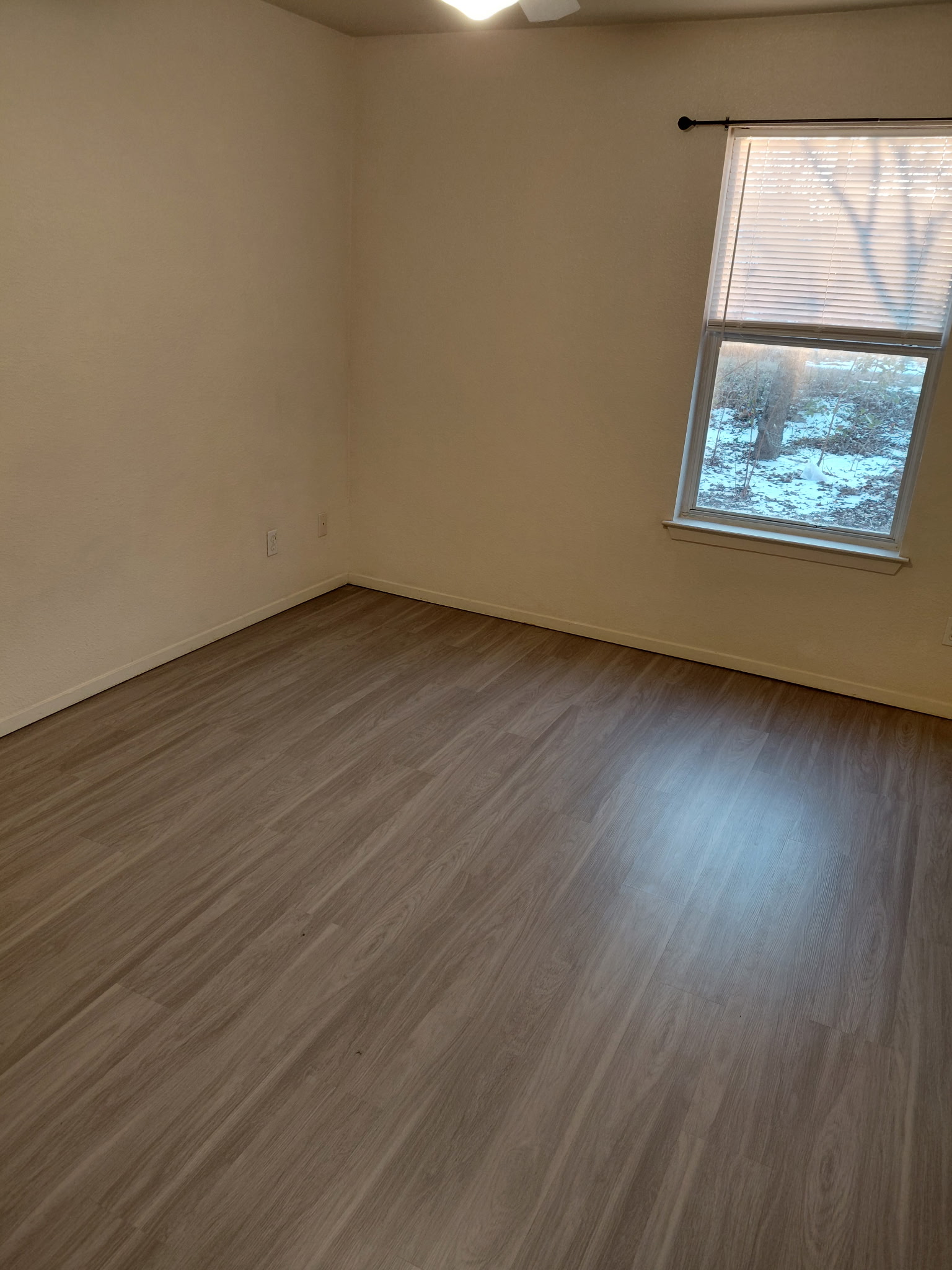 2218 Katy Lane Georgetown, TX 78626 - Photo 8 of 10 an empty room with wooden floor and windows