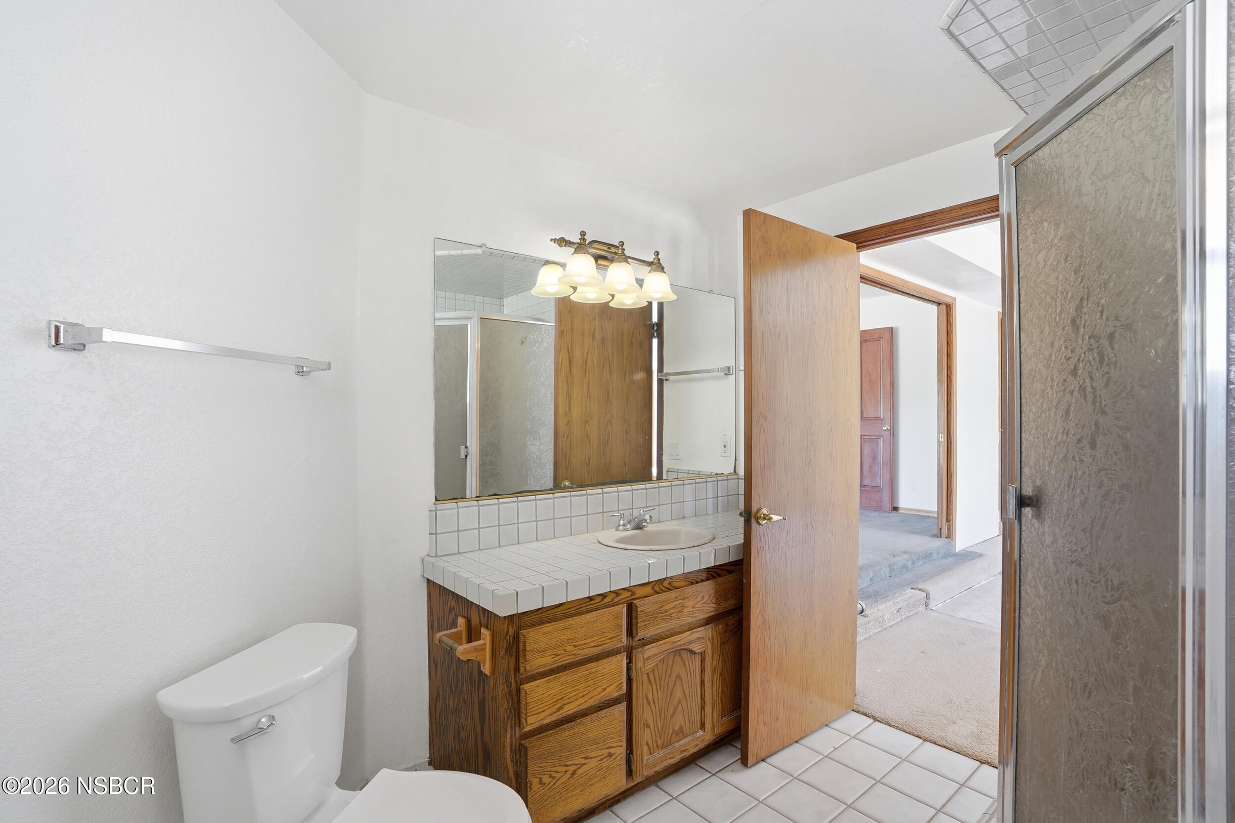 140 East Rice Ranch Road Santa Maria, CA 93455 - Photo 18 of 44 a bathroom with a granite countertop sink and a mirror