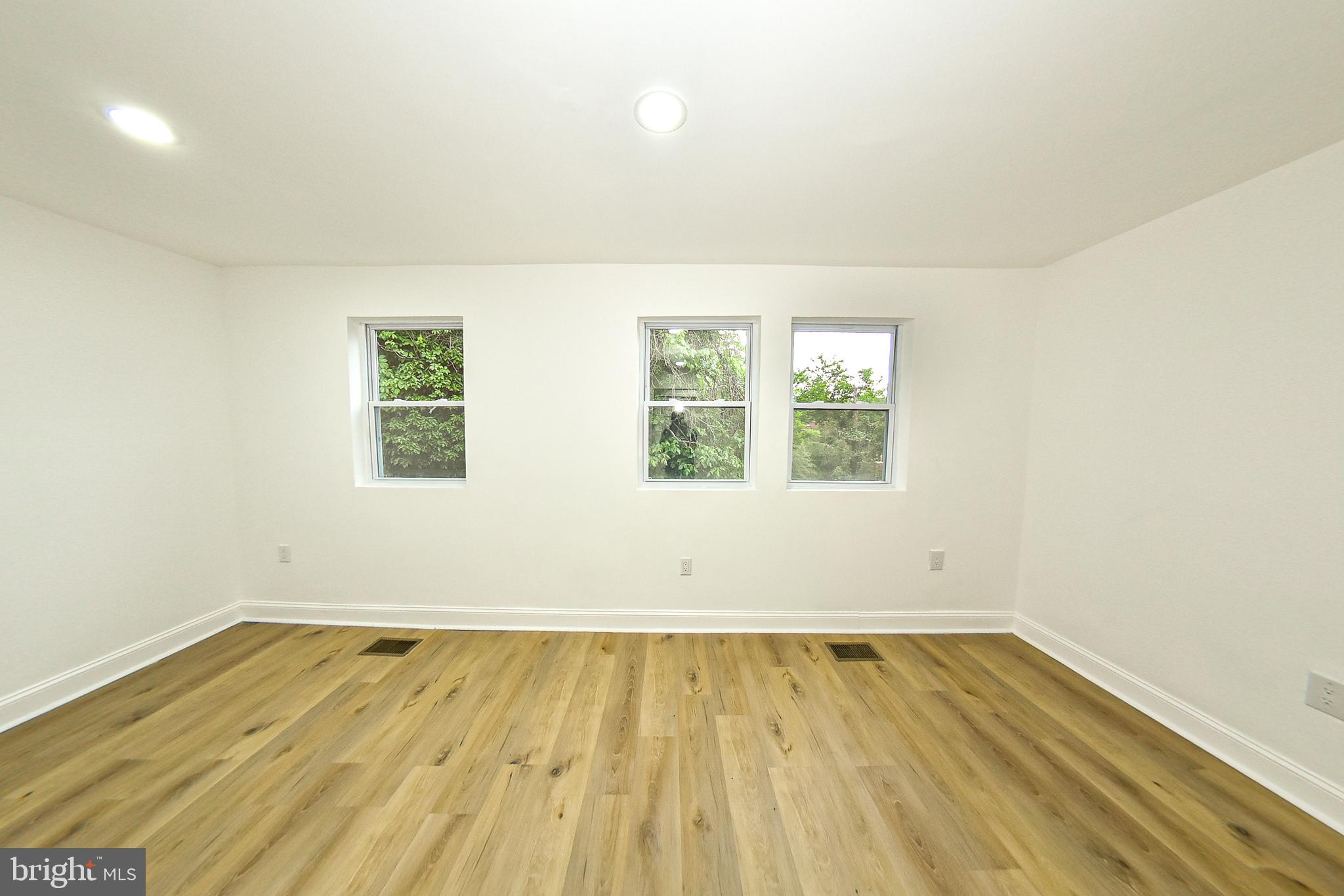 3704 Suitland Road Southeast Washington, DC 20020 - Photo 31 of 70 an empty room with wooden floor and windows