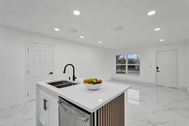 a kitchen with a sink and a refrigerator