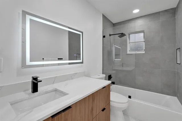 a bathroom with a sink a toilet and bathtub