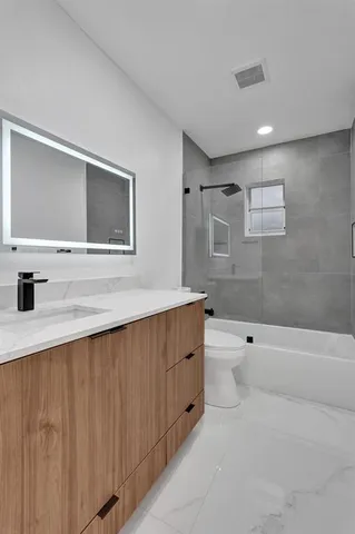 a bathroom with a bathtub and a toilet