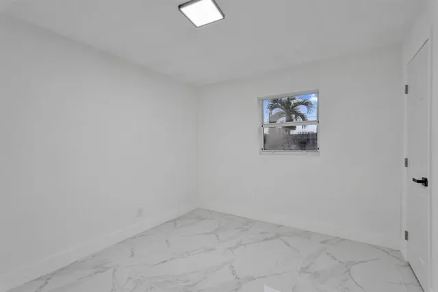 an empty room with a painting on the wall