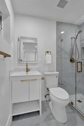 a bathroom with a toilet sink and shower