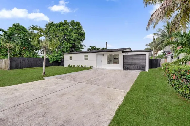 a view of a house with a yard and a garage