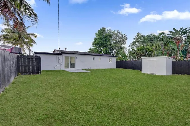 a front view of house with a garden