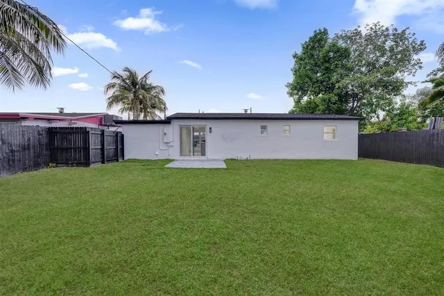 a front view of a house with a garden and yard