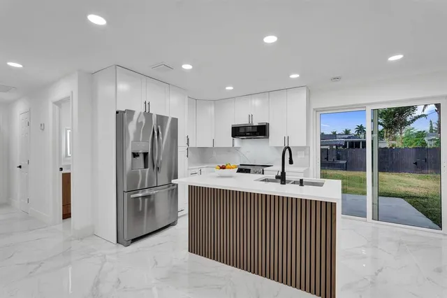 a kitchen with refrigerator and cabinets
