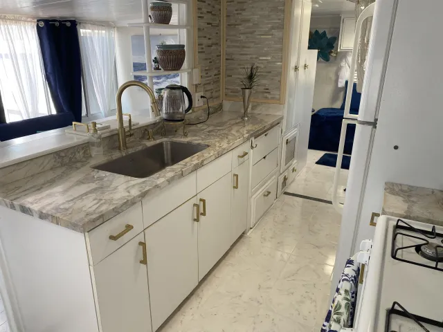 a close view of a sink a faucet and a stove in a bathroom
