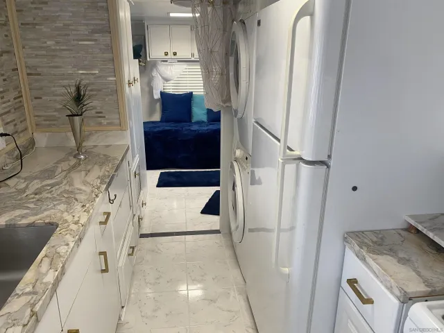 a bathroom with a granite countertop sink a toilet and shower