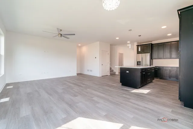 a large room with wooden floor and windows