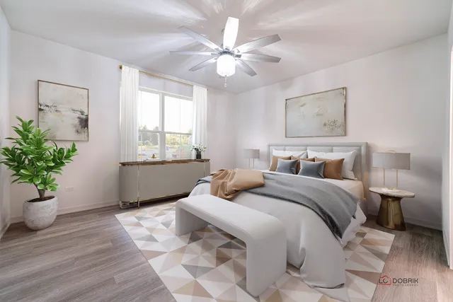 a bedroom with a large bed chandelier and a window