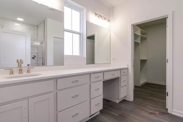 a spacious bathroom with double sink and a mirror