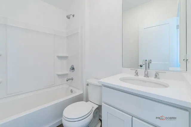 a bathroom with a sink toilet vanity and bathtub