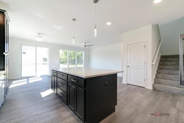 a kitchen with wooden floors and cabinets