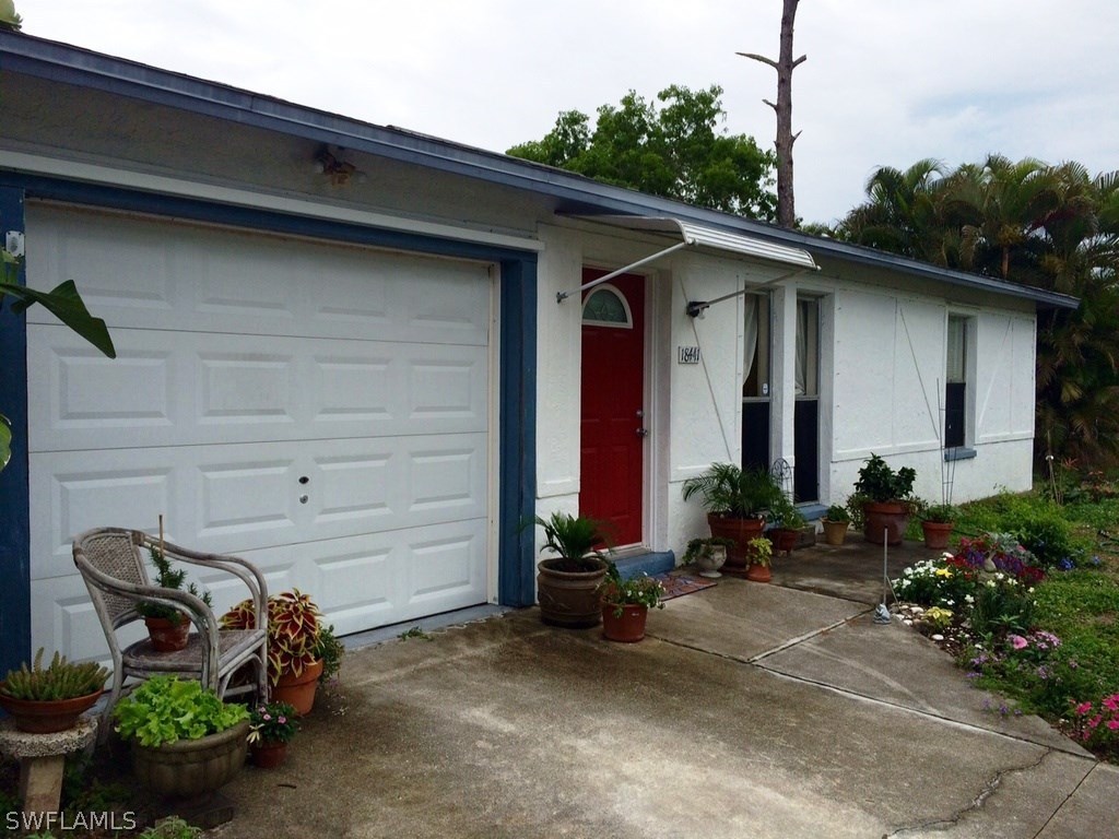 a couple of potted plants in front of door