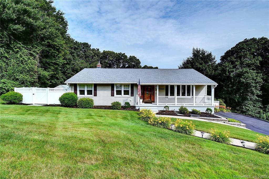 208 Juniper Ridge Drive Waterbury, CT 06708 - Photo 1 of 1 a front view of a house with a yard table and chairs