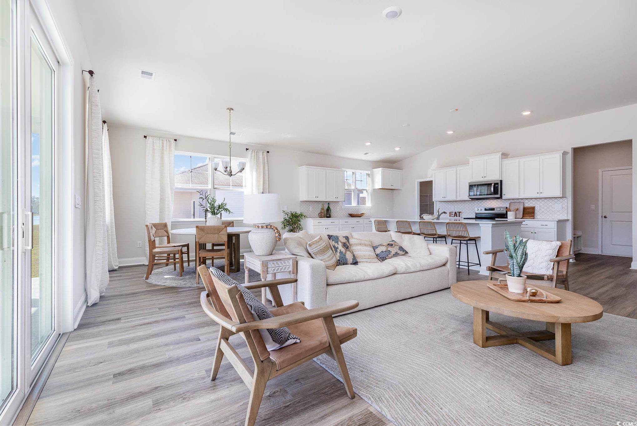 187 Bjorn Way Loris, SC 29569 - Photo 20 of 40 Living room featuring light wood-type flooring, a chandelier, recessed lighting, and lofted ceiling