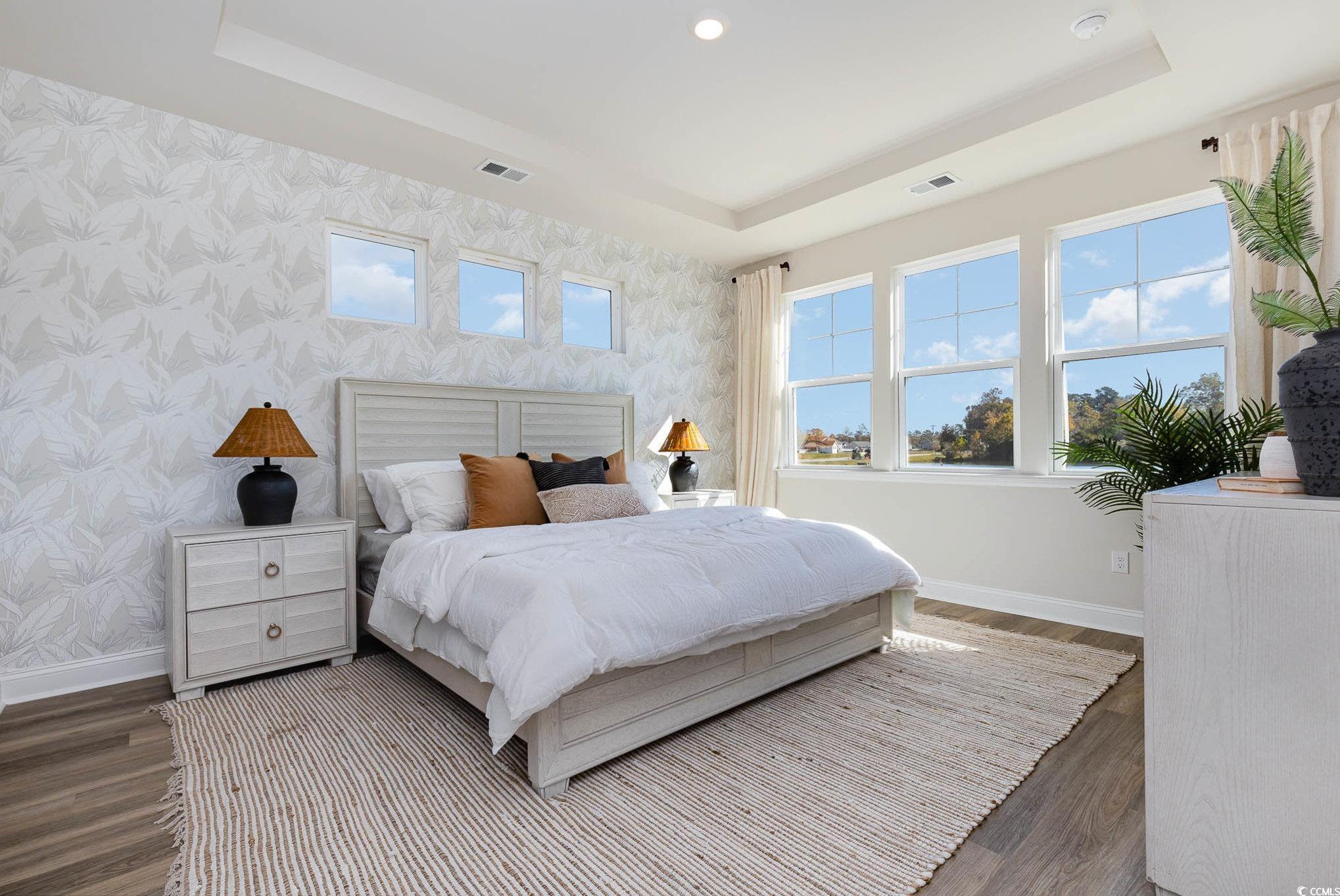 187 Bjorn Way Loris, SC 29569 - Photo 22 of 40 Bedroom with a raised ceiling, wood finished floors, and wallpapered walls