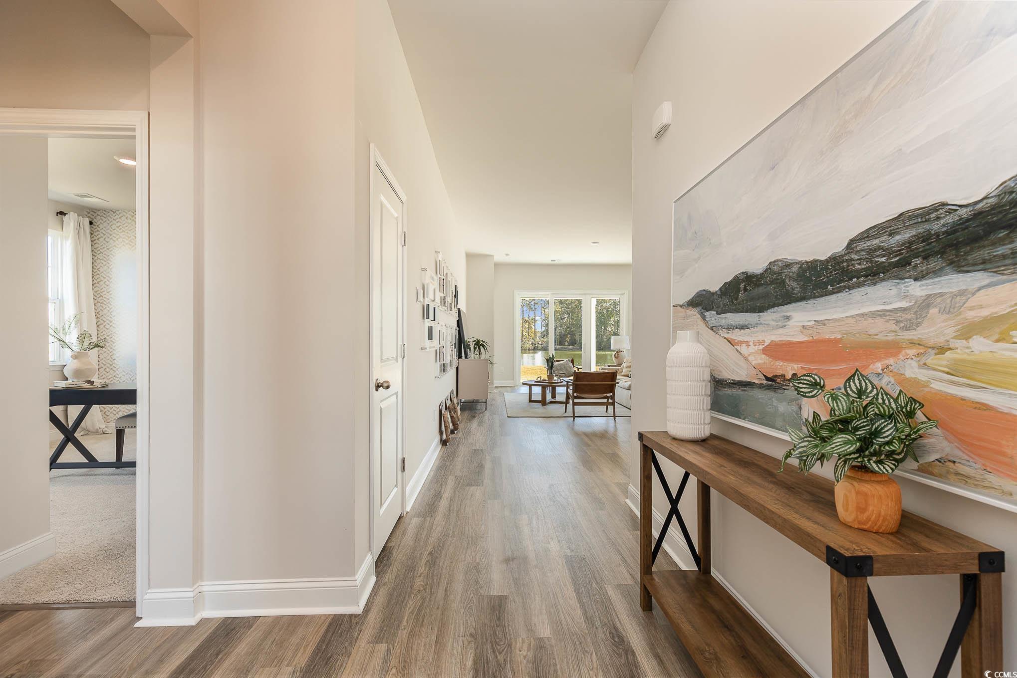 187 Bjorn Way Loris, SC 29569 - Photo 6 of 40 Hall with wood finished floors and baseboards