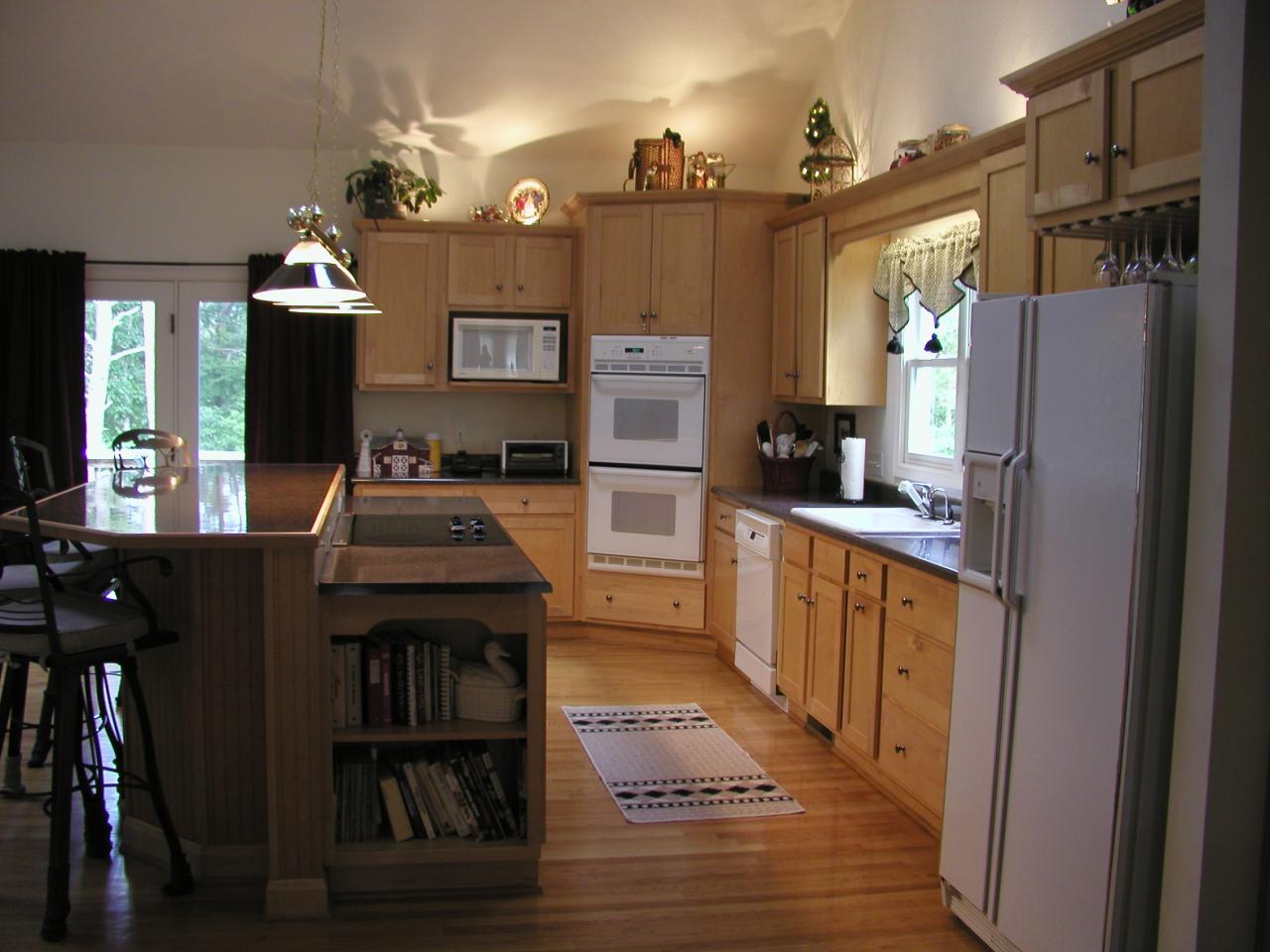 2905 New Ridge Road Elliston, VA 24087 - Photo 3 of 11 a kitchen with stainless steel appliances granite countertop a refrigerator a stove and a dining table with wooden floor