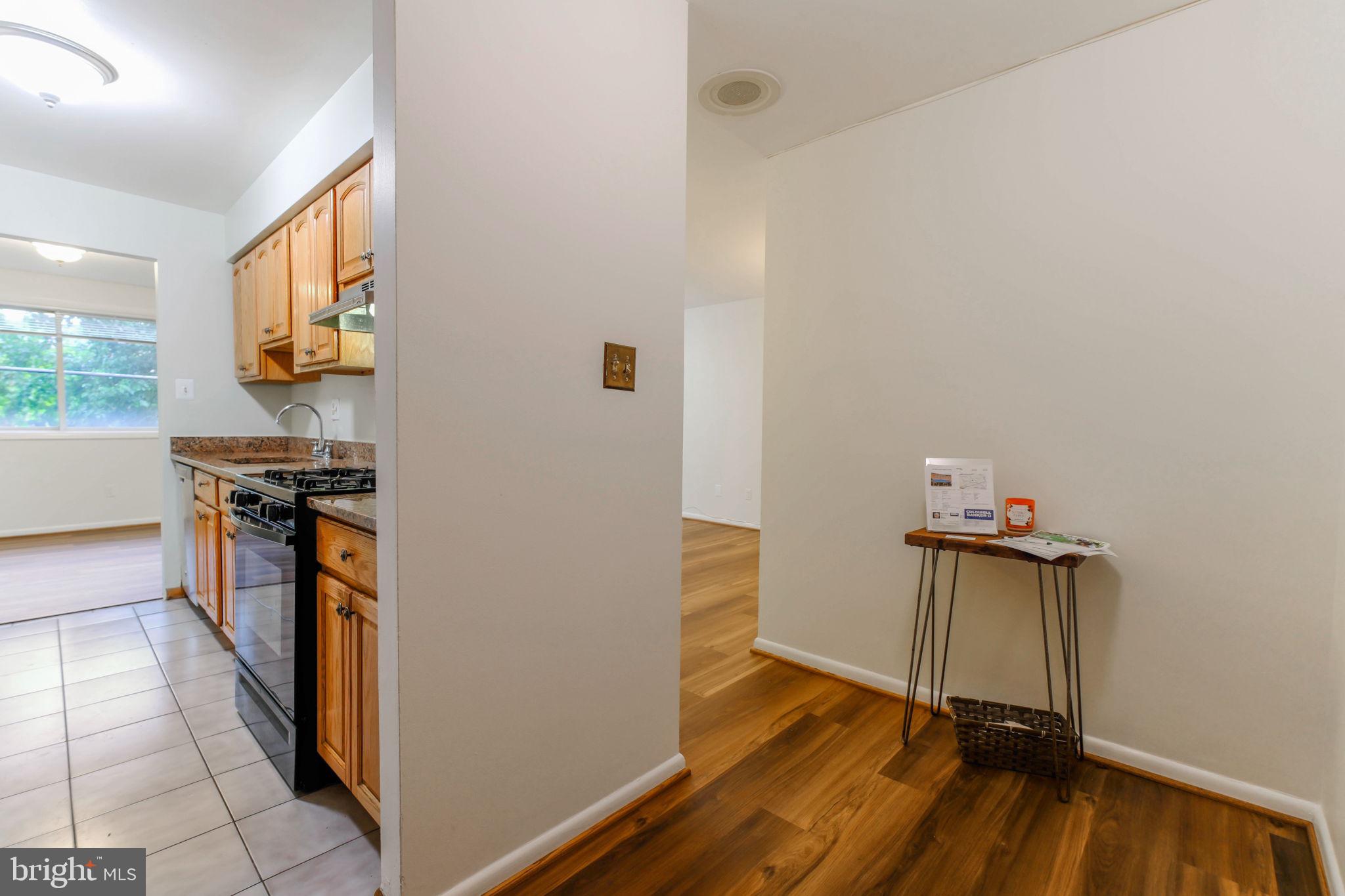 5101 8th Road South, Unit 102 Arlington, VA 22204 - Photo 11 of 19 a view of a kitchen with fridge and wooden floor