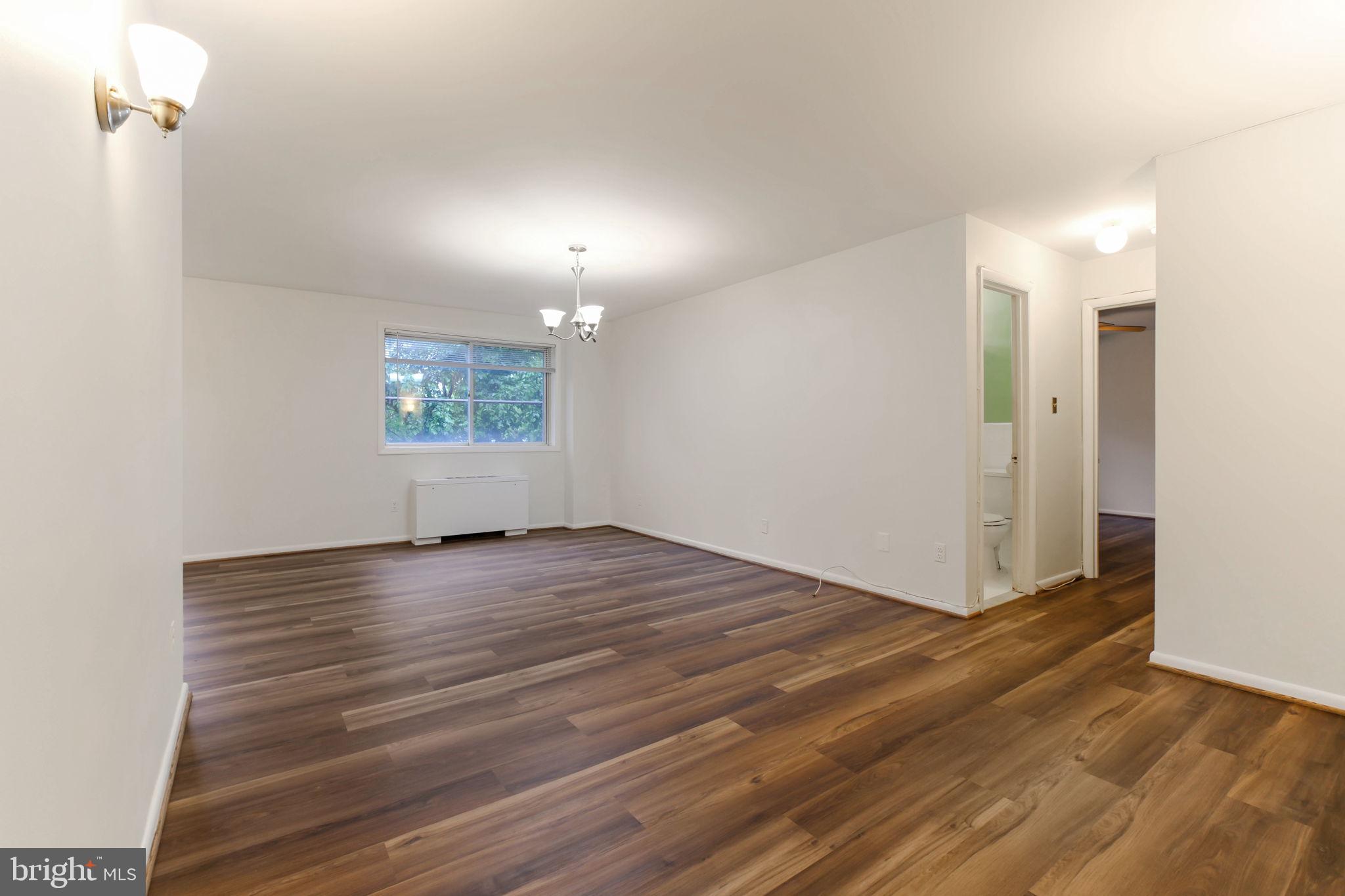 5101 8th Road South, Unit 102 Arlington, VA 22204 - Photo 12 of 19 an empty room with wooden floor and windows