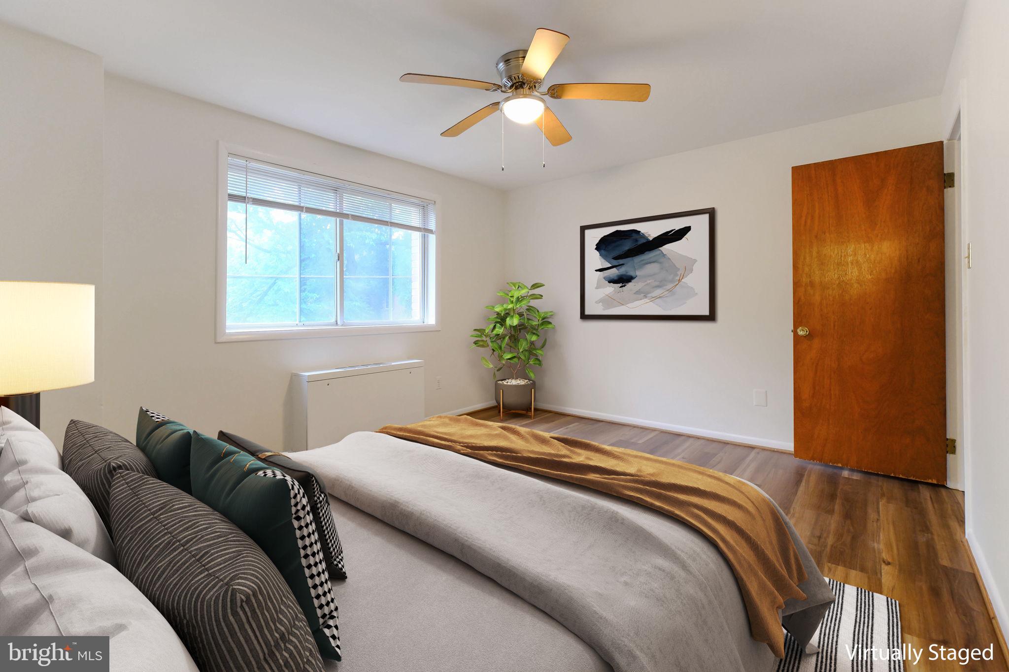5101 8th Road South, Unit 102 Arlington, VA 22204 - Photo 3 of 19 a bedroom with a bed and a painting on the wall