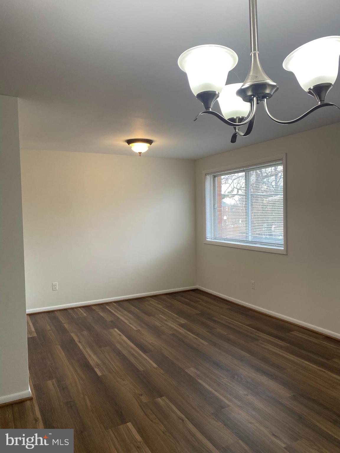 5101 8th Road South, Unit 102 Arlington, VA 22204 - Photo 9 of 22 a view of a room with wooden floor and a large window