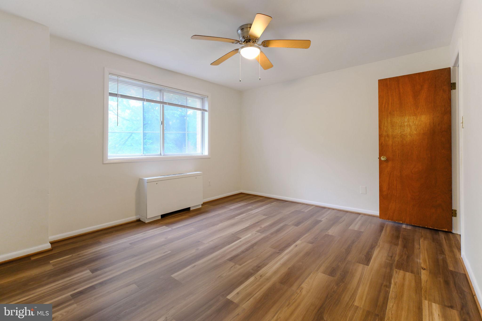5101 8th Road South, Unit 102 Arlington, VA 22204 - Photo 9 of 19 an empty room with wooden floor and windows