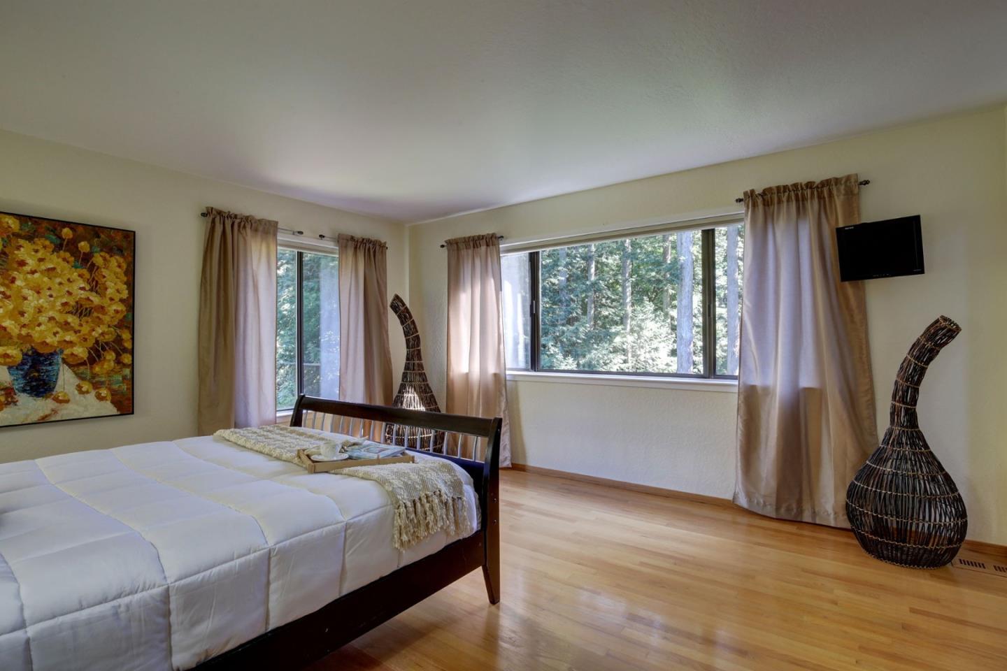 450 Bear Valley Road Aptos, CA 95003 - Photo 18 of 46 a bedroom with a bed a window and dresser