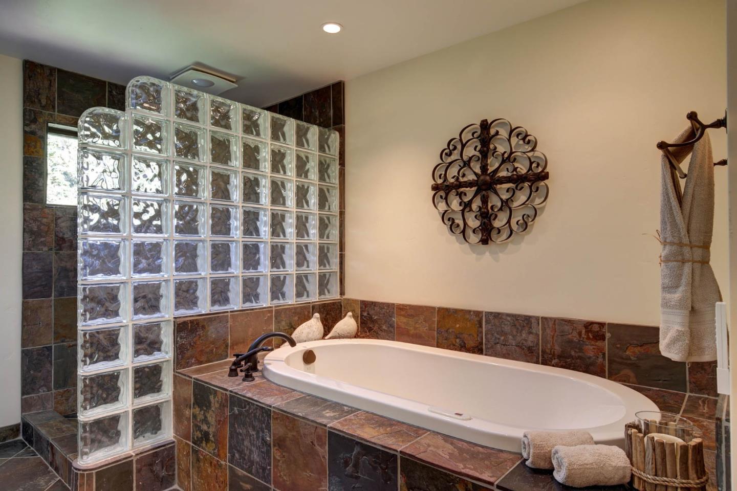 450 Bear Valley Road Aptos, CA 95003 - Photo 23 of 46 a bathroom with a bathtub and a shower