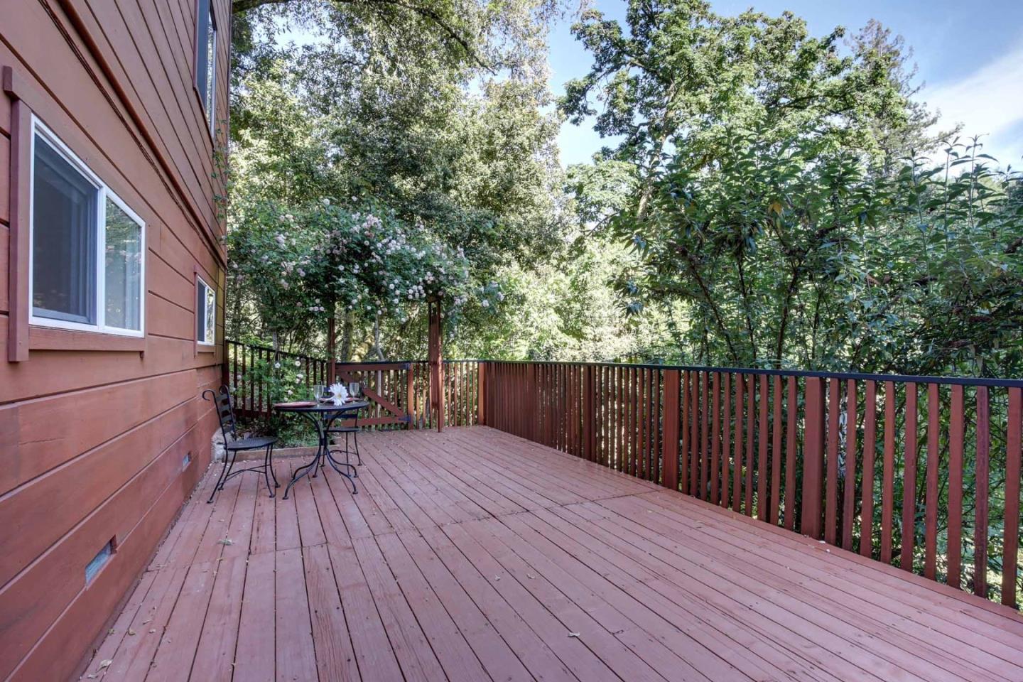 450 Bear Valley Road Aptos, CA 95003 - Photo 35 of 46 a balcony with wooden floor and outdoor seating
