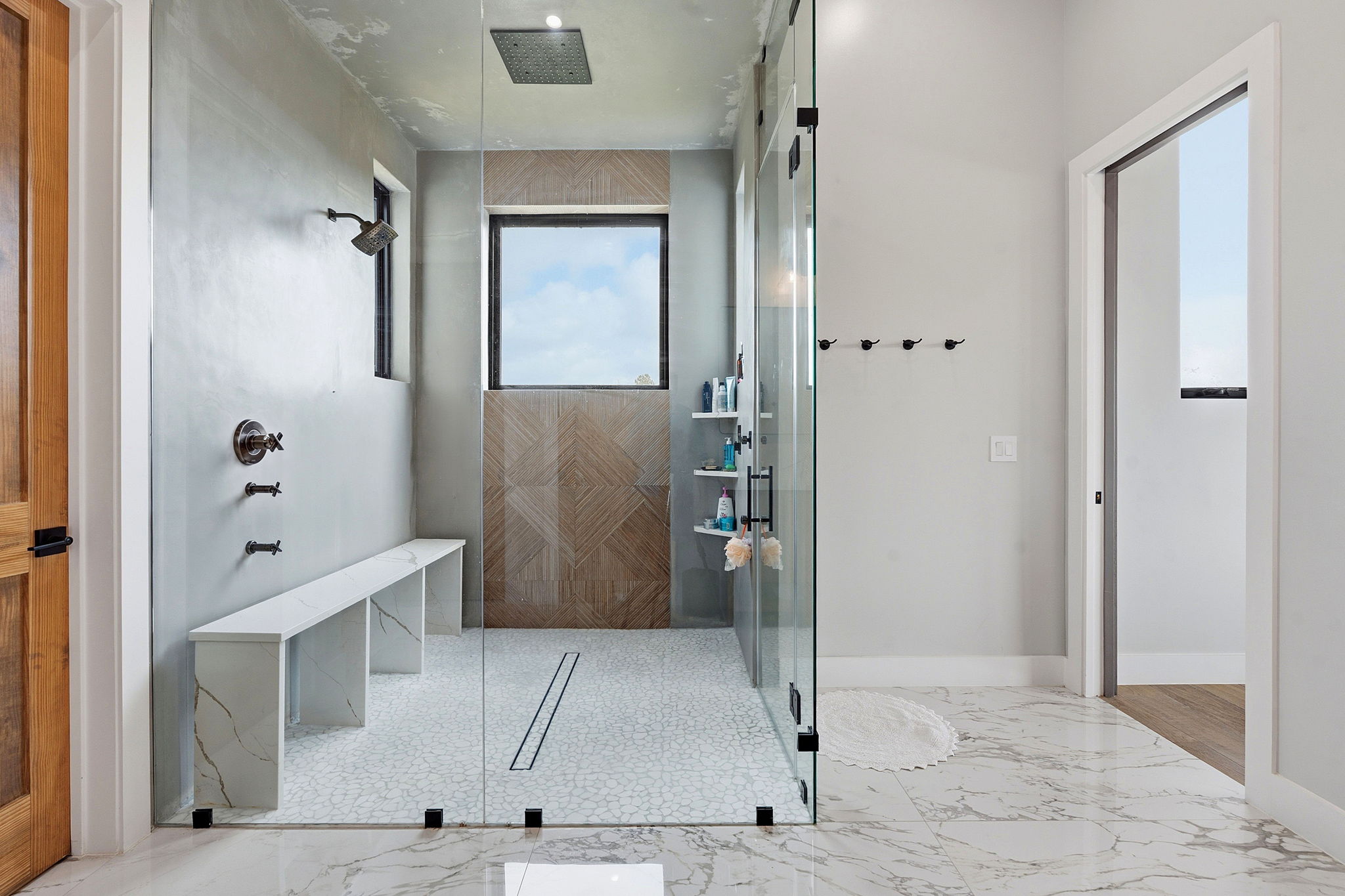 194 Placid Way Spring Branch, TX 78070 - Photo 14 of 37 Spacious shower enclosure with clear glass panels, a ceiling-mounted rainfall showerhead, and a wall-mounted shower faucet with a separate handheld spray