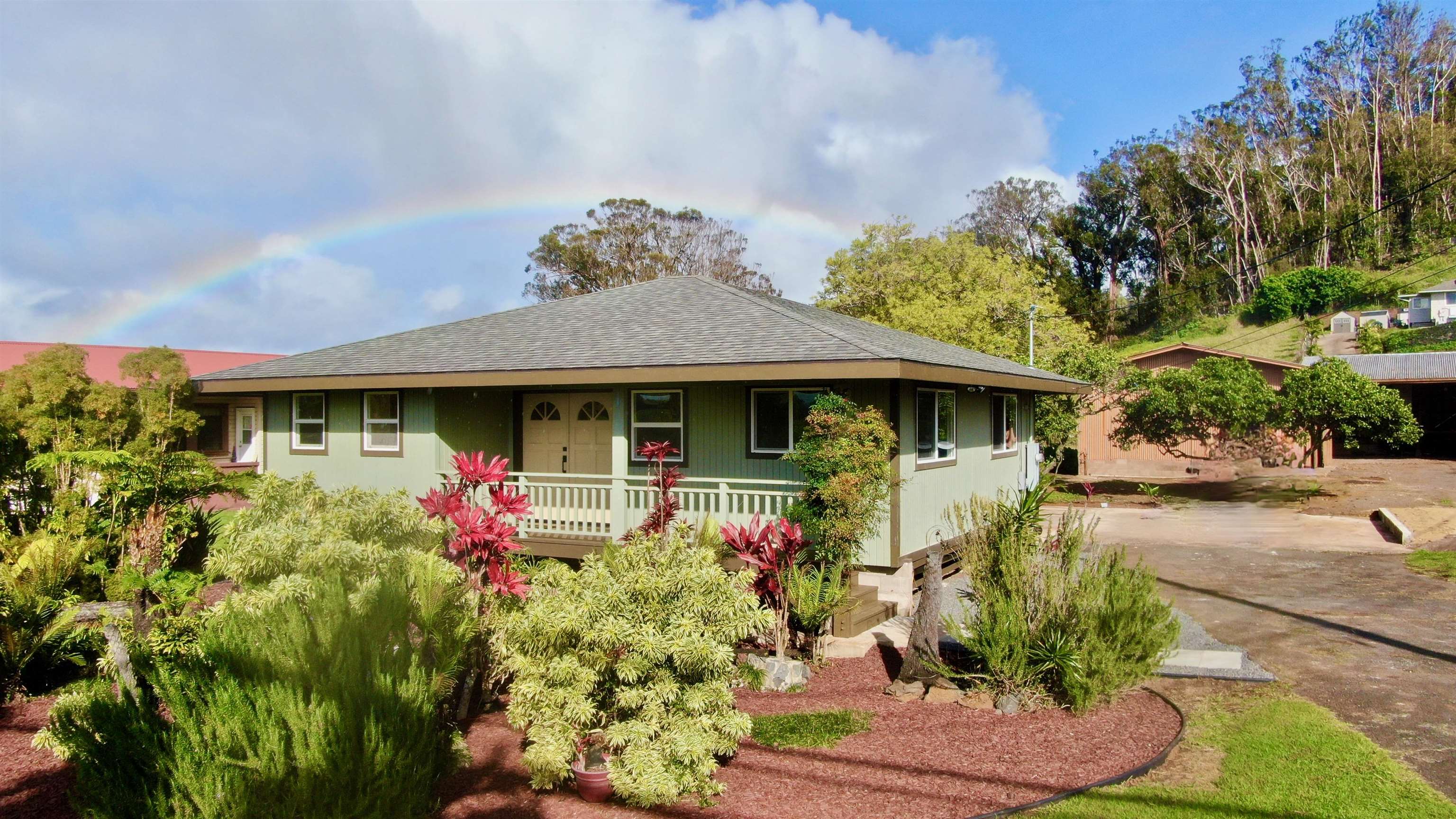 2835 Kaupakalua Road Haiku, HI 96708 - Photo 1 of 31 a front view of a house with garden