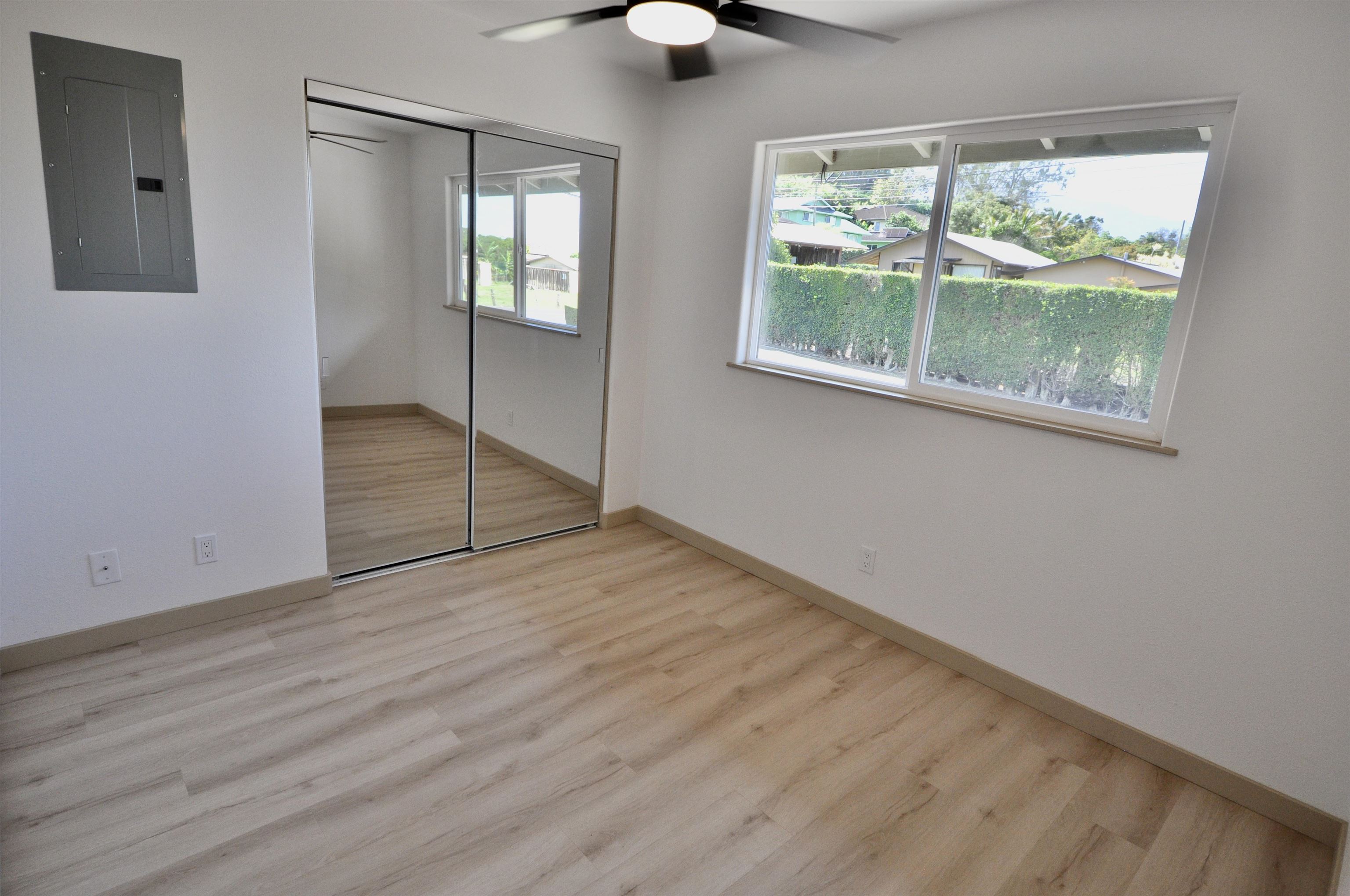 2835 Kaupakalua Road Haiku, HI 96708 - Photo 15 of 31 an empty room with wooden floor and windows