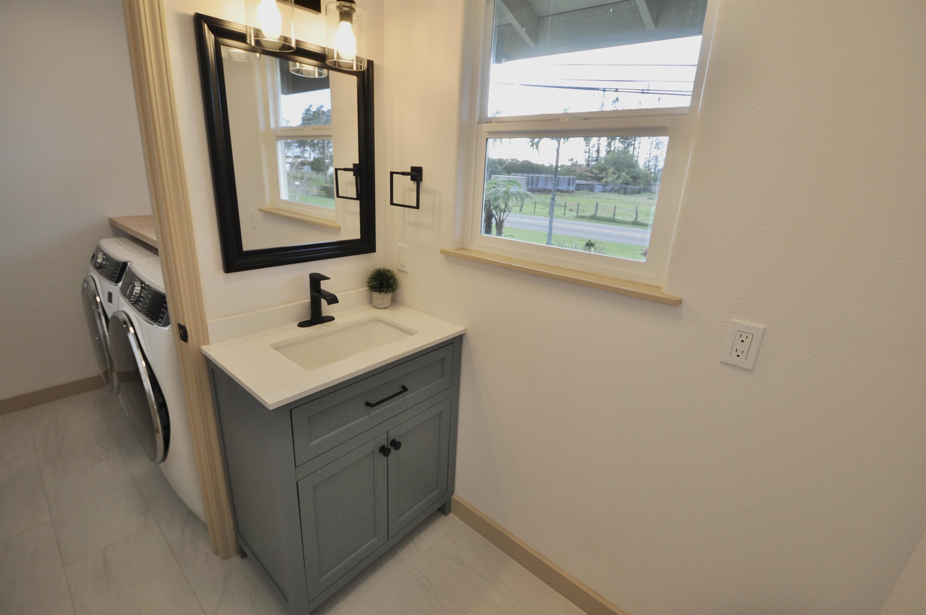 2835 Kaupakalua Road Haiku, HI 96708 - Photo 17 of 31 a bathroom with a sink a mirror and a window